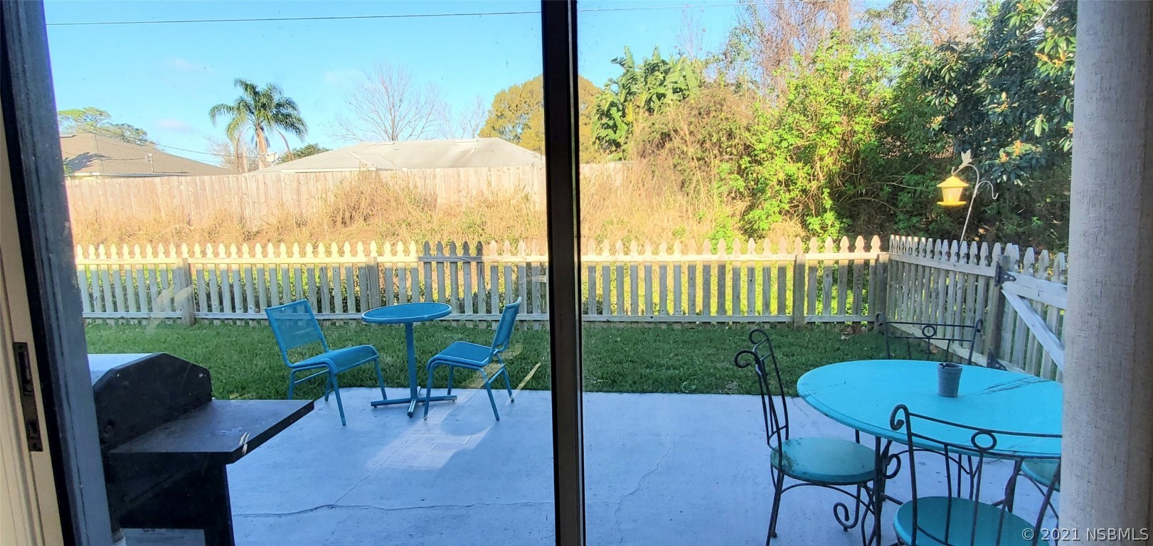 2219 Umbrella Tree Drive Edgewater, FL 32141 - Photo 10 of 45 a view of a porch with chairs and a table