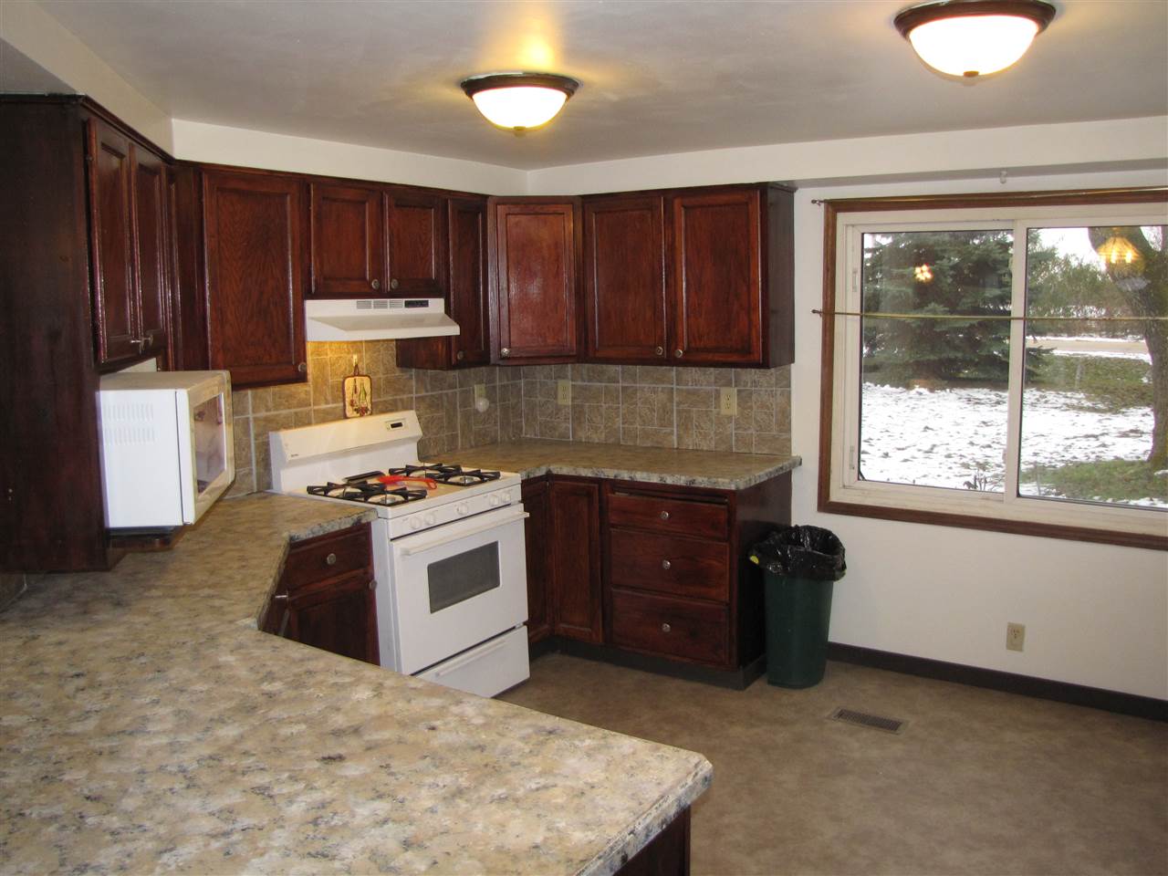3634 Rotary Road Rockford, IL 61109 - Photo 3 of 18 a kitchen with a stove a sink and a refrigerator