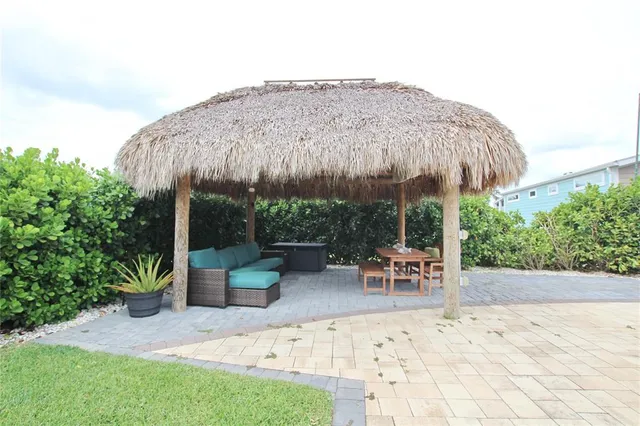 a backyard of a house with table and chairs