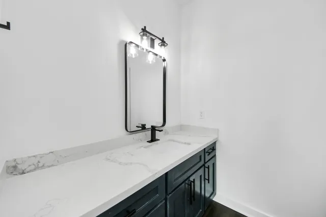 a bathroom with a sink and a mirror