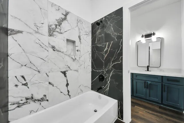 a bathroom with a bathtub and shower