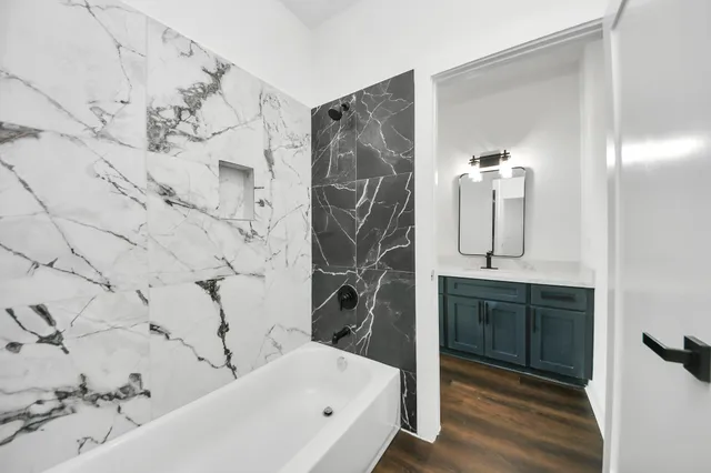 a bathroom with a bathtub and a shower