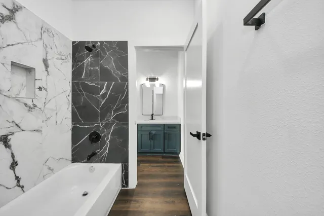 a bathroom with a bathtub and a shower