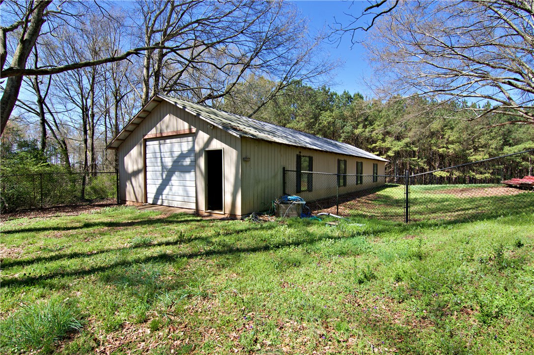 7893 Athens Road Carnesville, GA 30521 - Photo 37 of 50 This outdoor building offers practical storage space amidst a tranquil, natural setting.