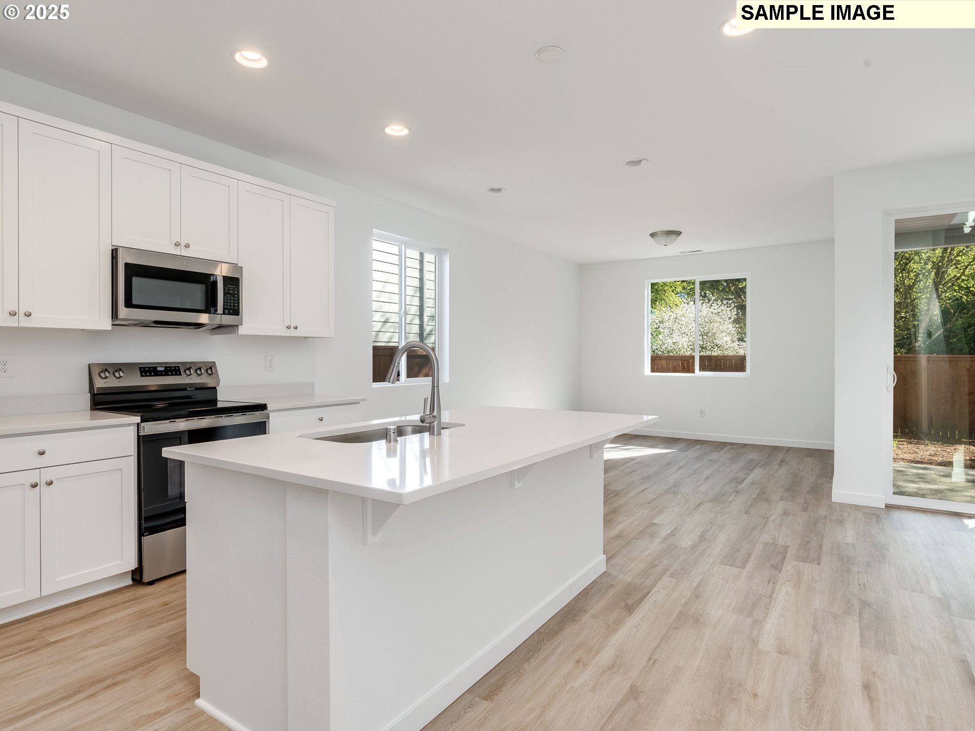 2307 Southwest 5th Circle Battle Ground, WA 98604 - Photo 6 of 21 a kitchen with stainless steel appliances granite countertop a sink stove and microwave