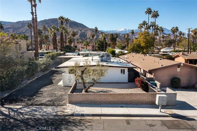 a view of a water fountain and front of the house