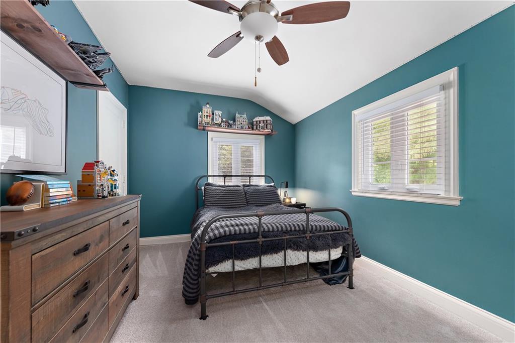 607 Davis Lane Sewickley, PA 15143 - Photo 28 of 43 a bedroom with a bed and a chandelier