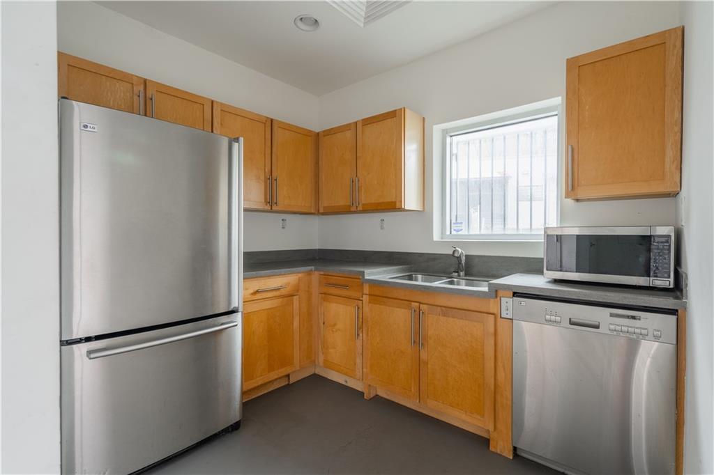 692 10th Street Northwest Atlanta, GA 30318 - Photo 13 of 38 a white refrigerator freezer sitting in a kitchen
