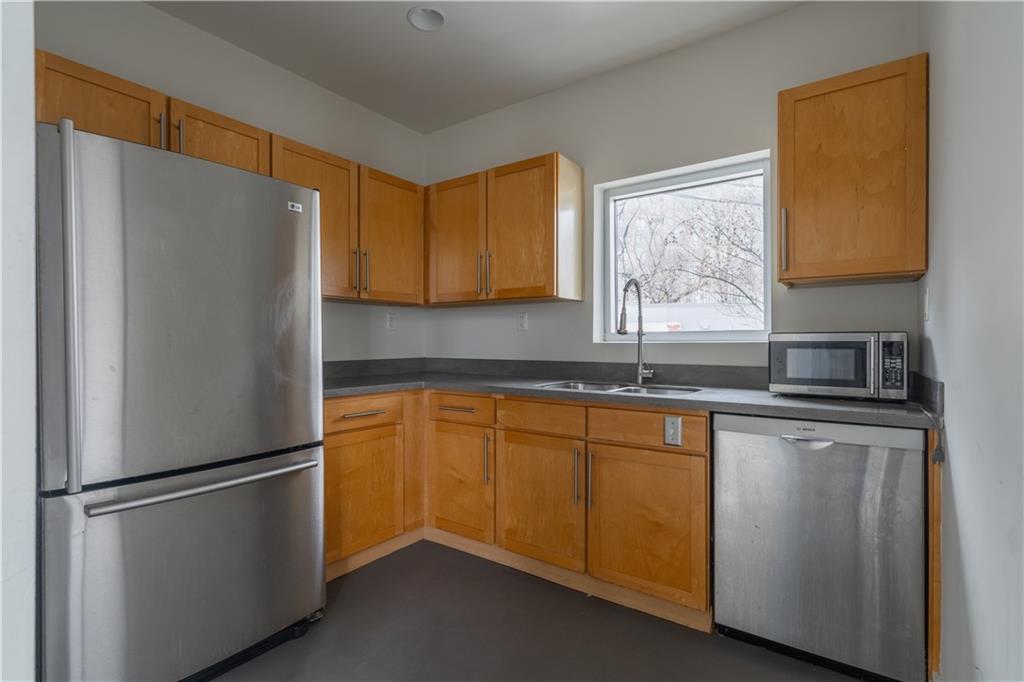 692 10th Street Northwest Atlanta, GA 30318 - Photo 25 of 38 a kitchen with stainless steel appliances granite countertop a refrigerator and a sink