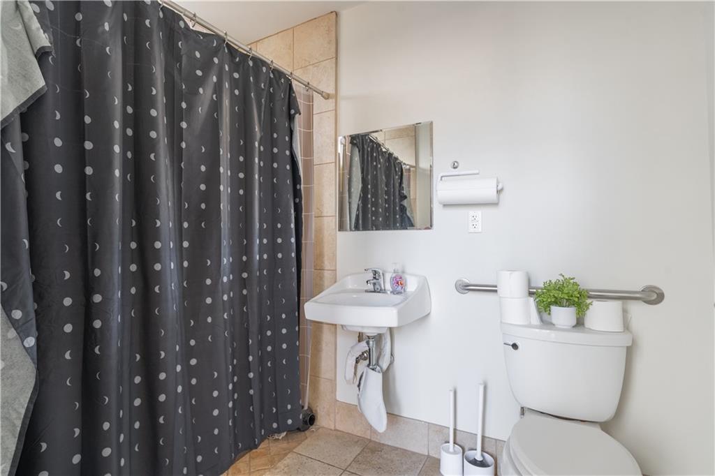 692 10th Street Northwest Atlanta, GA 30318 - Photo 27 of 38 a bathroom with a sink toilet and shower