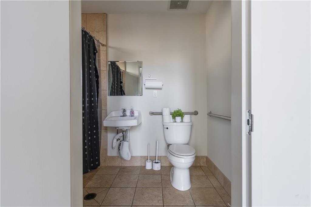 692 10th Street Northwest Atlanta, GA 30318 - Photo 28 of 38 a bathroom with a toilet and a sink