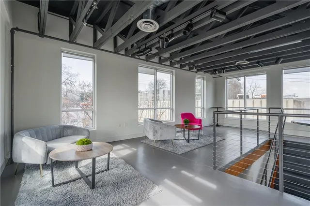 a living room with furniture and a floor to ceiling window