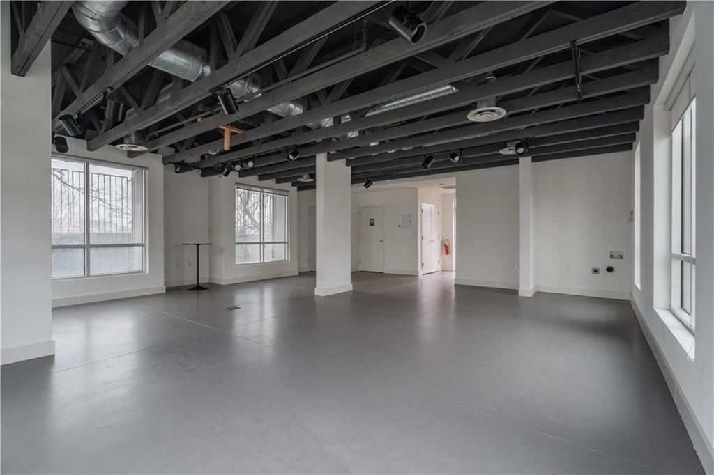 692 10th Street Northwest Atlanta, GA 30318 - Photo 4 of 38 a view of empty room with wooden floor and windows