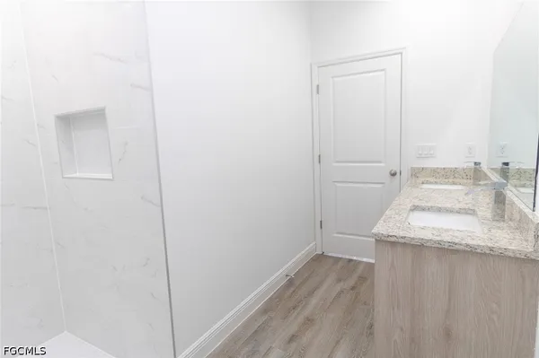a bathroom with a granite countertop sink and vanity