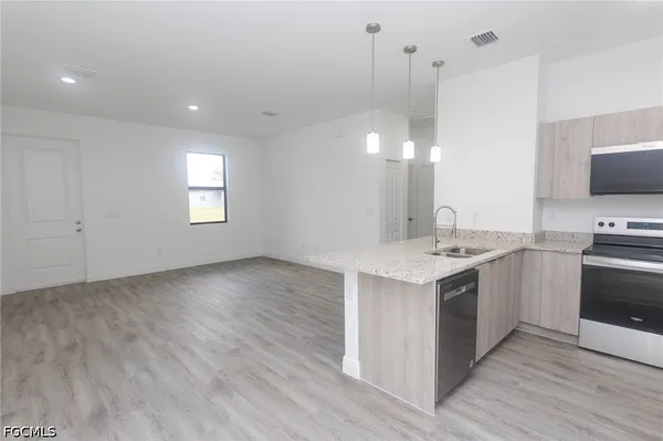 a kitchen with a stove and a white kitchen island