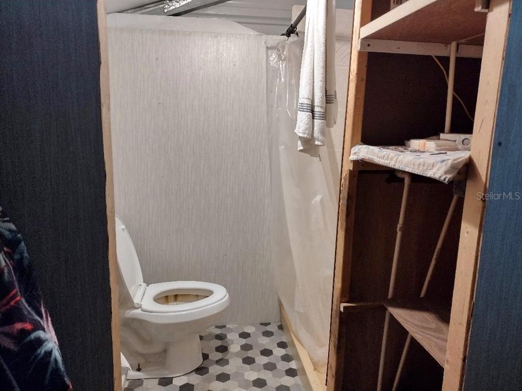 1568 Hazelnut Street Bunnell, FL 32110 - Photo 17 of 19 a bathroom with a toilet and a shower