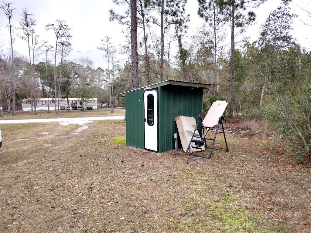 1568 Hazelnut Street Bunnell, FL 32110 - Photo 18 of 19 a green field with some trees in the background