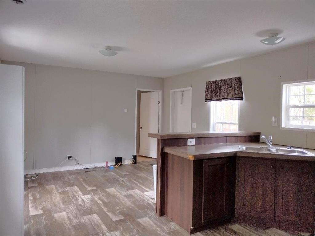 1568 Hazelnut Street Bunnell, FL 32110 - Photo 2 of 19 a kitchen with granite countertop a sink and a stove