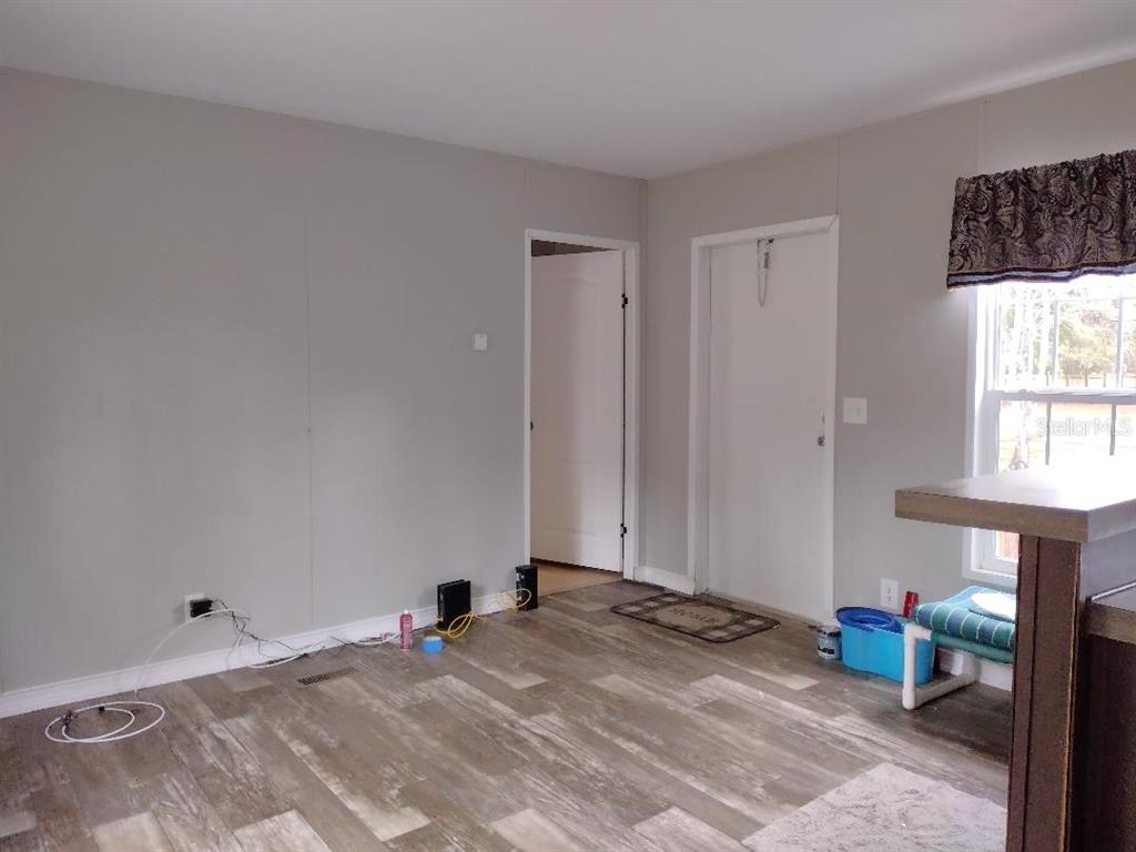 1568 Hazelnut Street Bunnell, FL 32110 - Photo 4 of 19 a view of a livingroom with wooden floor and a window