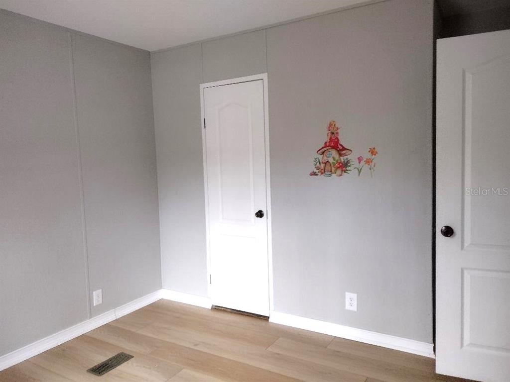 1568 Hazelnut Street Bunnell, FL 32110 - Photo 6 of 19 a view of entryway with wooden floor