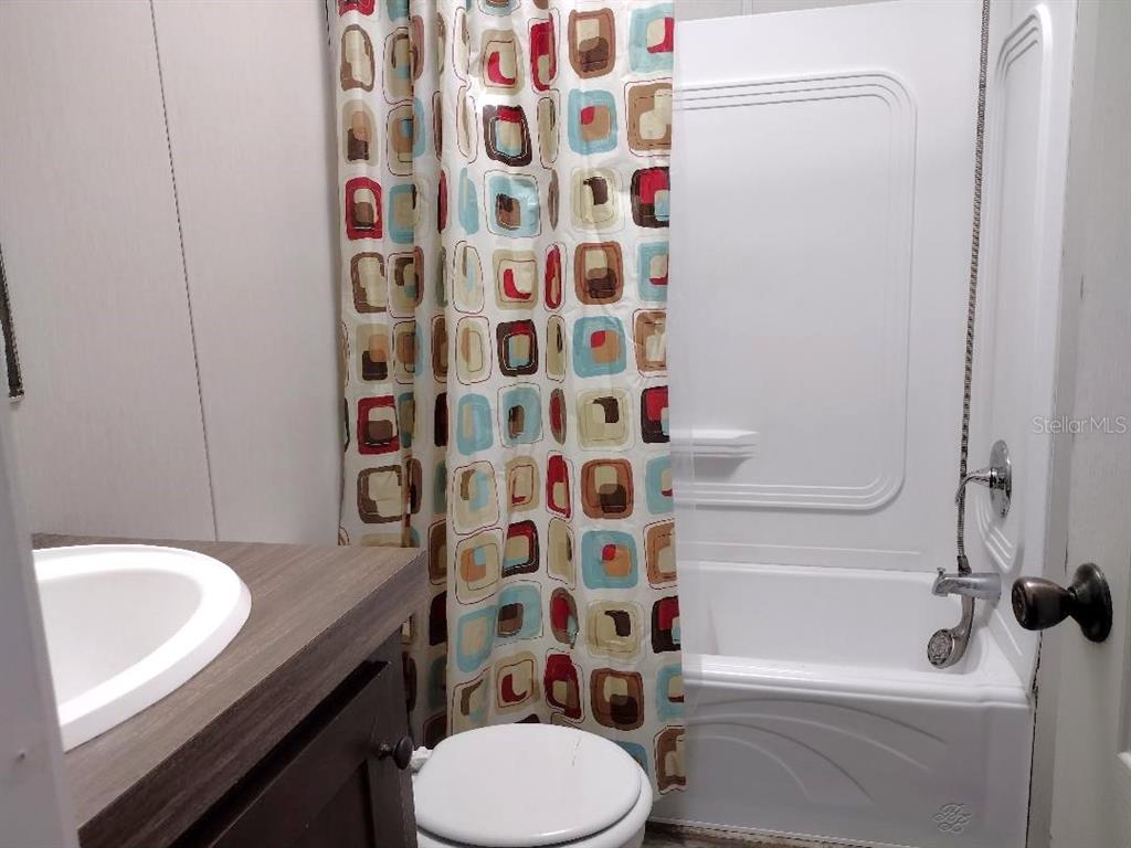 1568 Hazelnut Street Bunnell, FL 32110 - Photo 8 of 19 a bathroom with a sink toilet and shower