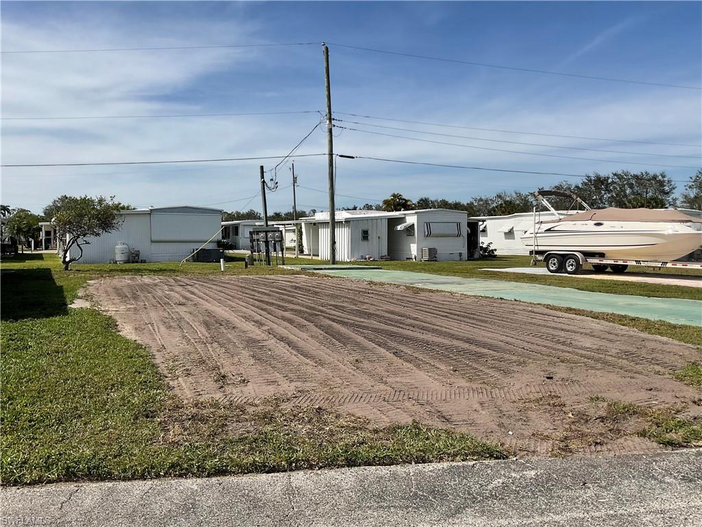143 Rose Lane Naples, FL 34114 - Photo 2 of 13 a car parked on the side of the road