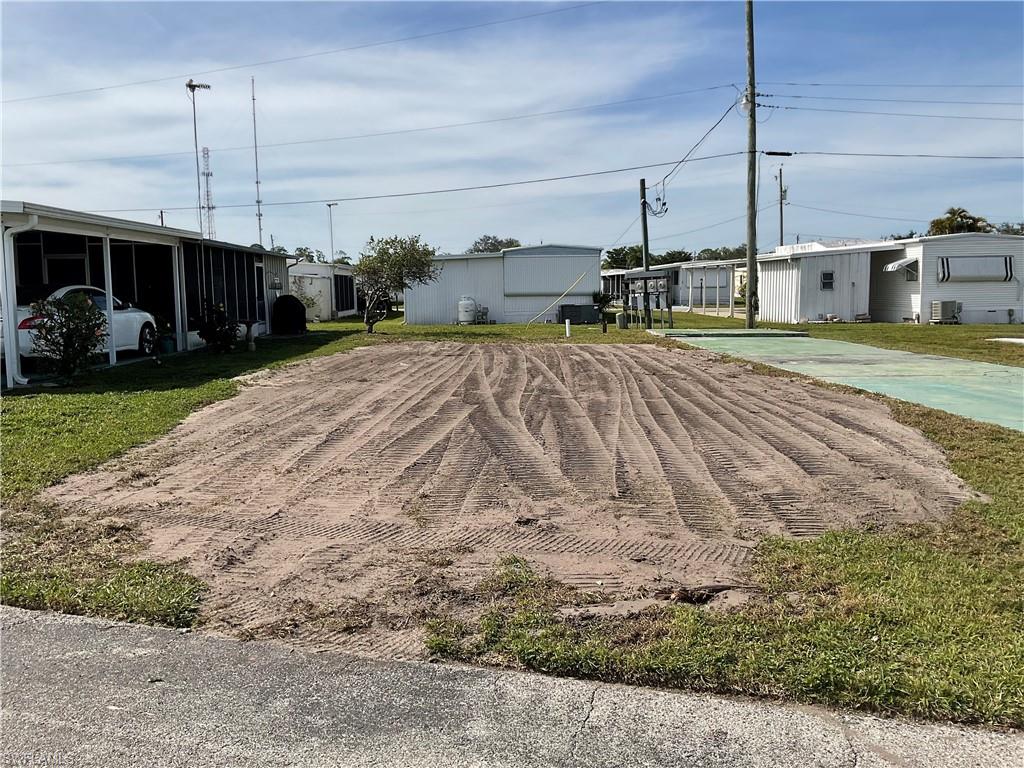 143 Rose Lane Naples, FL 34114 - Photo 3 of 13 a front view of a house with a yard
