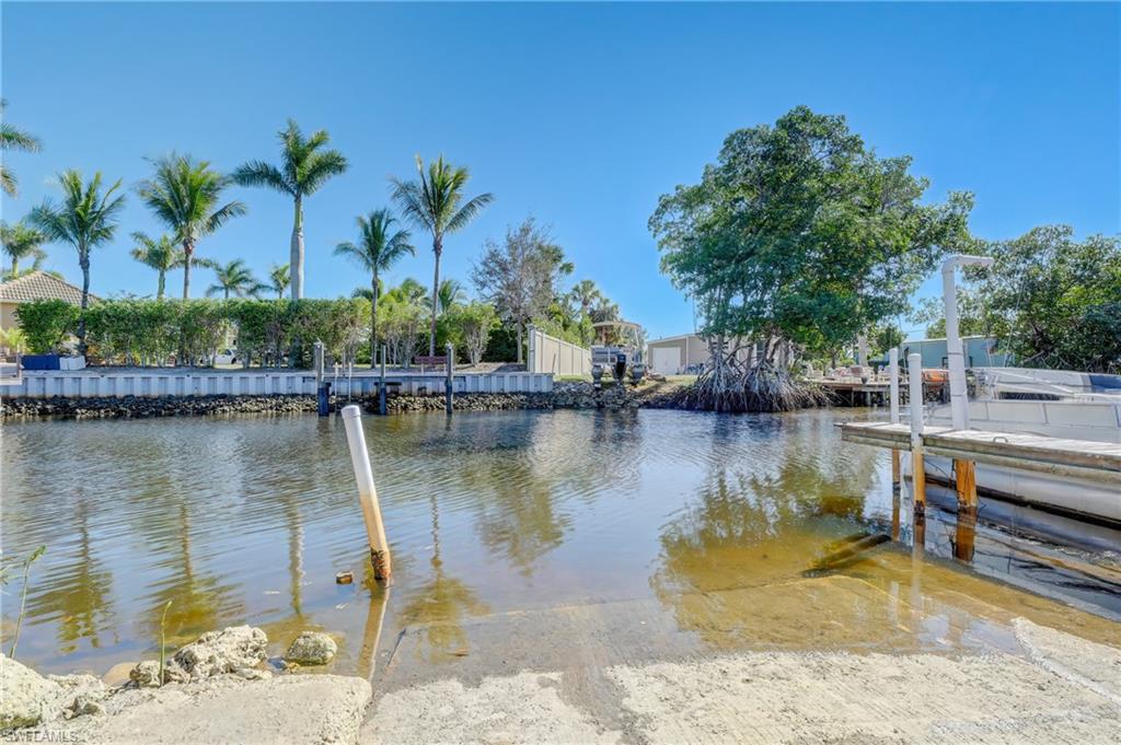 143 Rose Lane Naples, FL 34114 - Photo 10 of 13 a view of a lake with a house