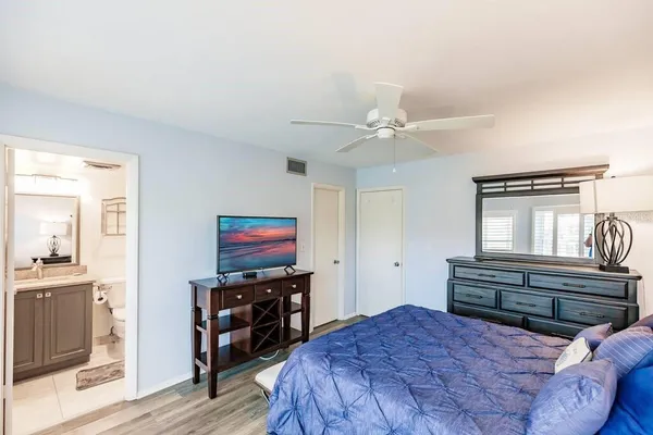 a bedroom with a bed and wooden floor