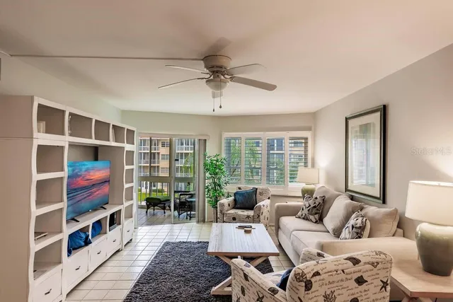 a living room with furniture and a book shelf