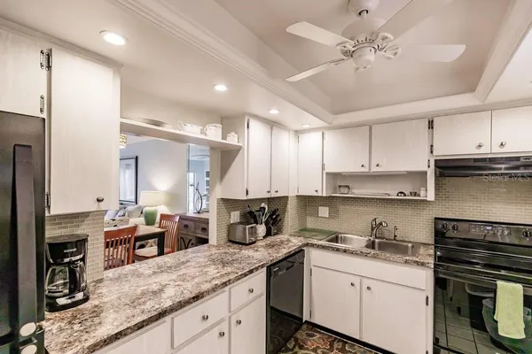 a kitchen with a sink stainless steel appliances and cabinets