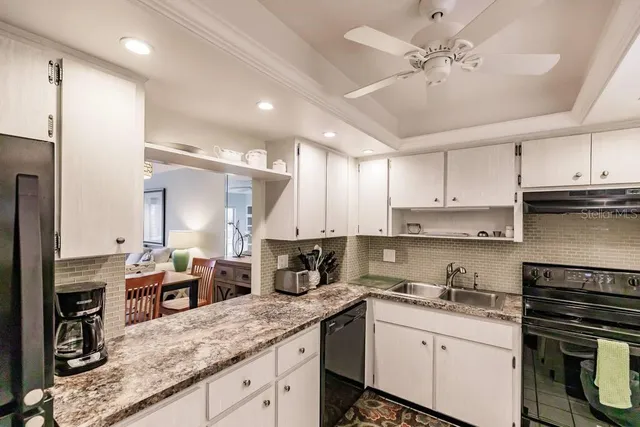 a kitchen with a sink stainless steel appliances and cabinets