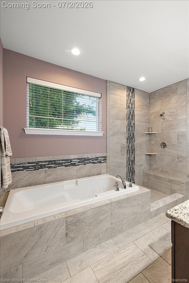 54230 Card Road Macomb, MI 48042 - Photo 55 of 73 Soaking tub with chrome fixtures, surrounded by large format tile