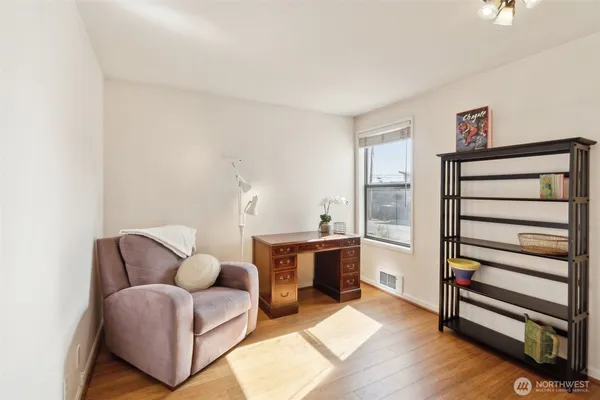 a living room with furniture a piano and a window