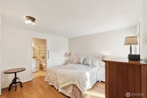 a bedroom with a bed and a lamp on table