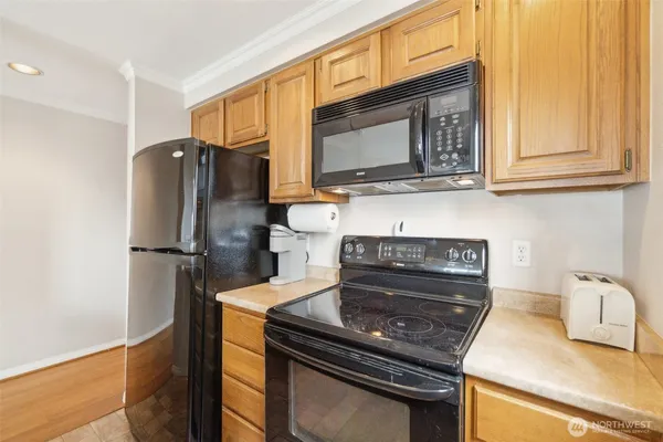 a kitchen with granite countertop a stove and a microwave