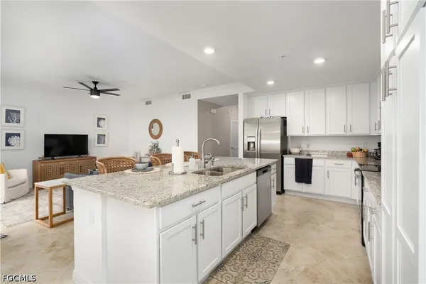 a kitchen with sink stove and refrigerator