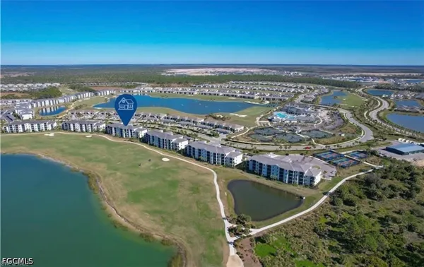 a aerial view of a multi story residential apartment building with yard and outdoor seating