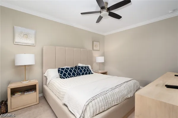 a bedroom with a bed and a lamp on the dresser