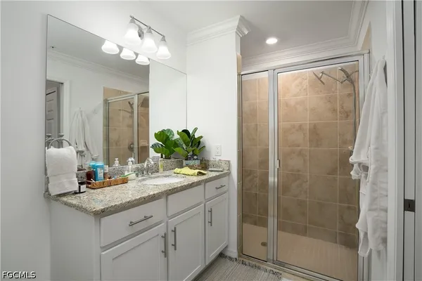 a bathroom with a shower sink and mirror