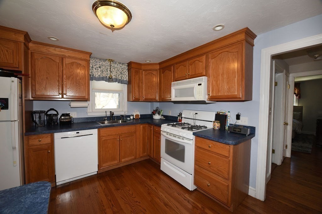 106 Rinaldo Road Weymouth, MA 02191 - Photo 6 of 39 a kitchen with stainless steel appliances granite countertop a stove a sink and a refrigerator