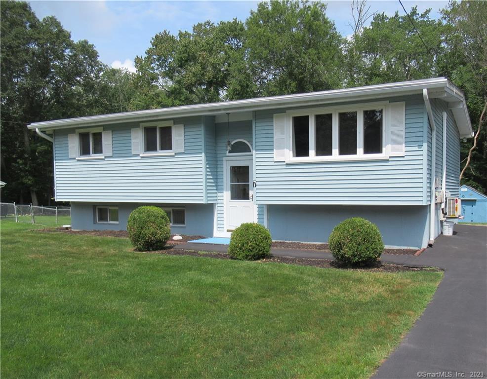 7 Pennywise Lane Ledyard, CT 06339 - Photo 1 of 1 a house with green field in front of it