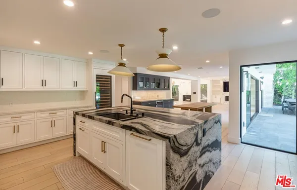 a kitchen with stainless steel appliances granite countertop a sink and a stove