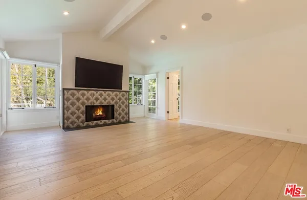 a view of a livingroom with a fireplace a fireplace and wooden floor