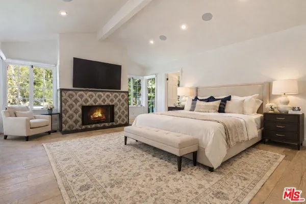 a bedroom with a bed and a fireplace