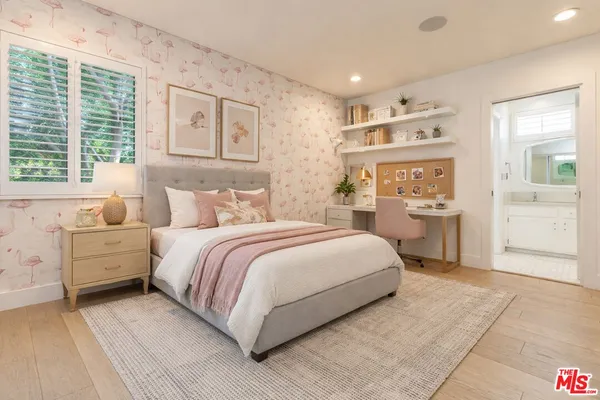 a bedroom with a large bed and a window