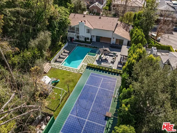 an aerial view of a house with garden space sitting space and swimming pool
