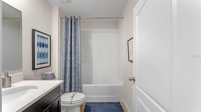 a living room with a bed furniture and a window