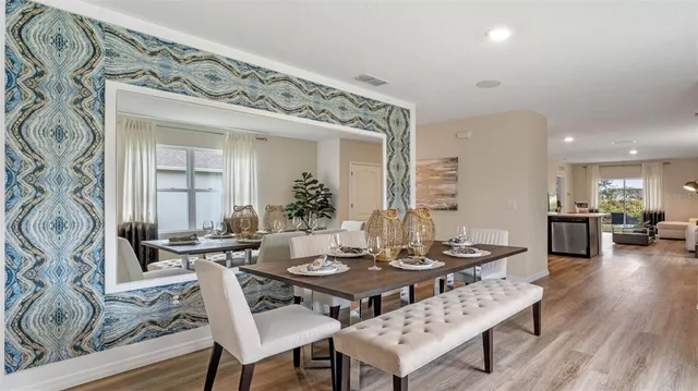 a dining room with furniture and wooden floor