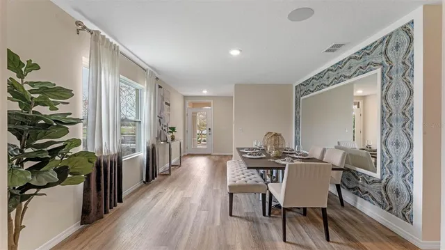 a view of a dining room with furniture and wooden floor